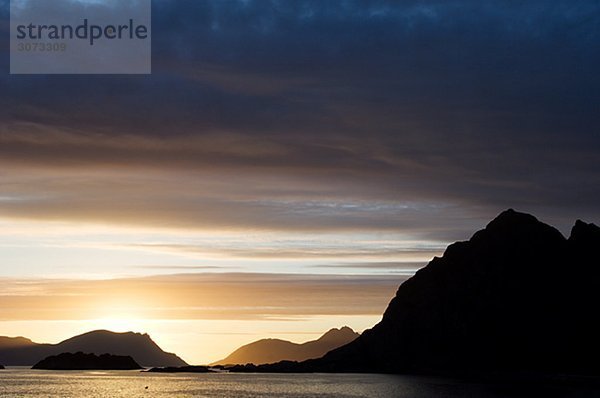 Ocean view and the midnight sun Henningsvaer Lofoten islands Norway.