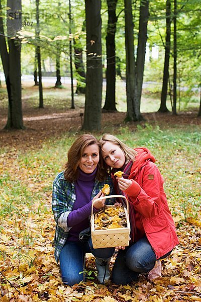 Mother and daughter picking mushrooms Sweden.