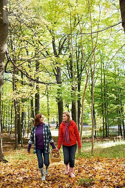 Mother and daughter walking in a forest Stockholm Sweden.