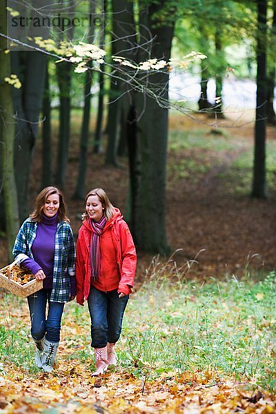 Mother and daughter walking in a forest Stockholm Sweden.