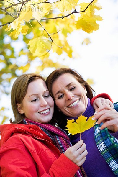 Mother and daughter holding a maple leaf Sweden.