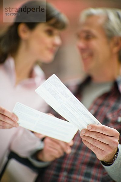 A couple looking at their tickets at a railway station Sweden.