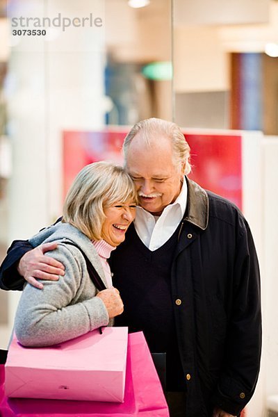 Senior couple carrying shopping bags Stockholm Sweden.