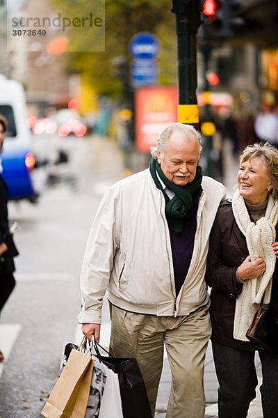 A senior couple carrying shopping bags Stockholm Sweden.