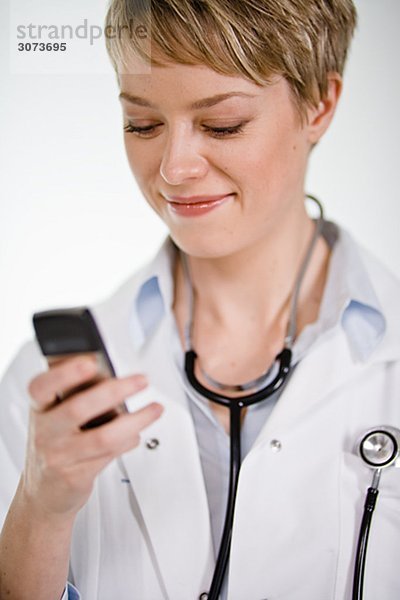 A female doctor using a mobile phone Sweden.