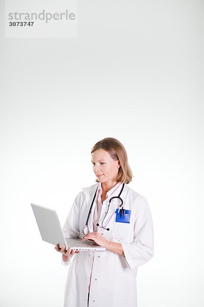 A doctor using a laptop.