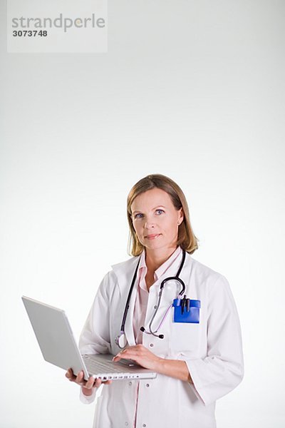 A doctor using a laptop.