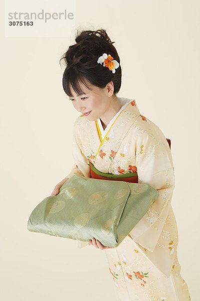Frau trägt Kimono hält Furoshiki