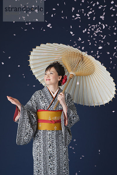 Frau in Kimono Standing hält Parasol