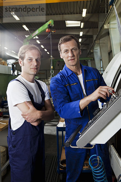 Zwei Handwerker in einer Metallteilefabrik