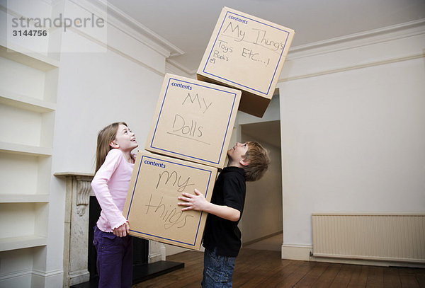 Zwei Kinder mit einem Kistenstapel