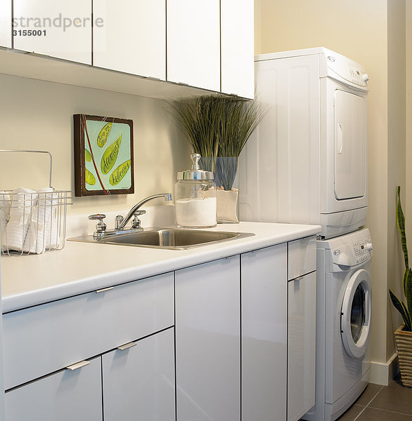 Laundry room with stacked washer and dryer
