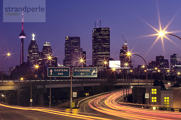 Toronto skyline and highway with light trails at dusk  Toronto  Ontario