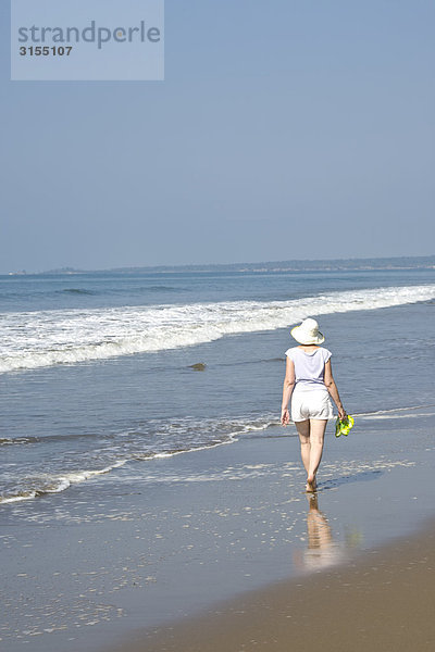 Rear view of woman walking on Beach  Mexico