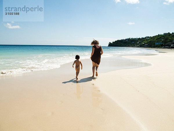 Boy and mother running on beach  Port Antonio  Portland  Jamaica