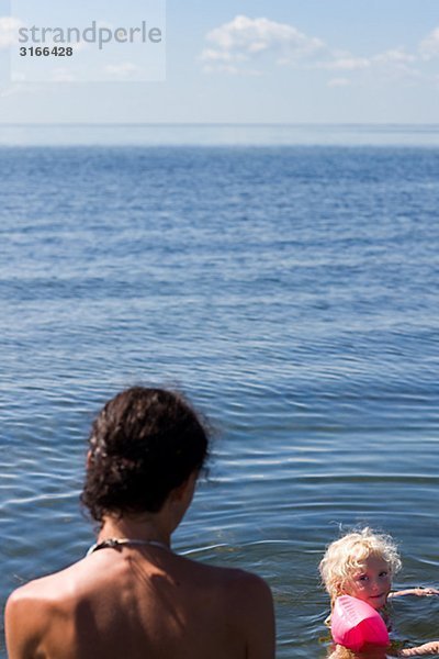 Mutter und Tochter Baden im Meer Schweden.