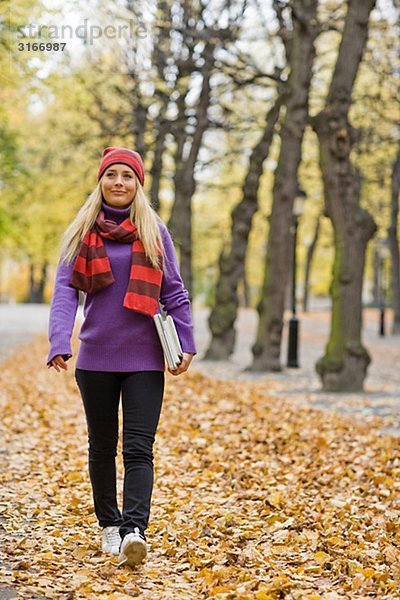 Eine Frau in einem Park im Herbst Schweden.