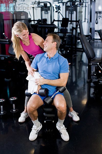 Ein Mann und eine Frau Krafttraining in einem Fitnessstudio Schweden.