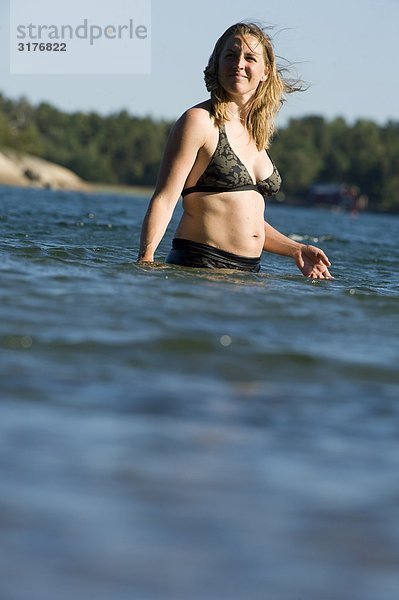 Eine Frau steht im Wasser  Schweden.
