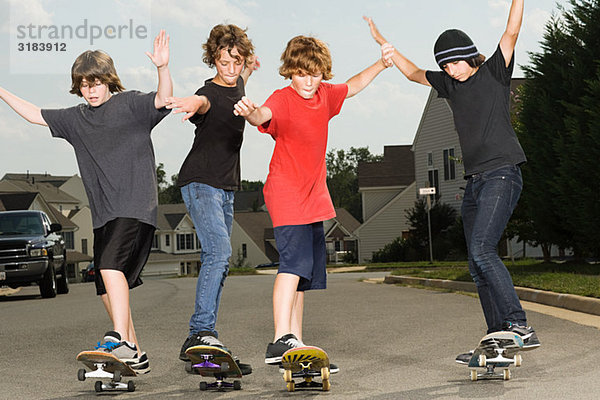 Vier Jungs beim Skateboarden