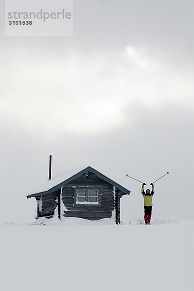 Person outside a mountain lodge  Sweden.