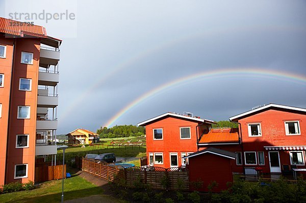 Rainbow over houses  Sweden.