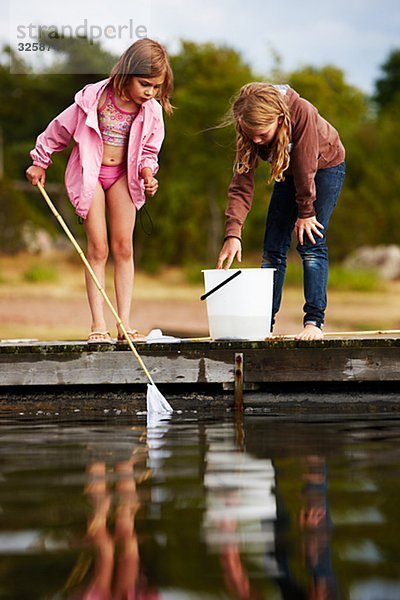 Two girls fishing  Sweden.