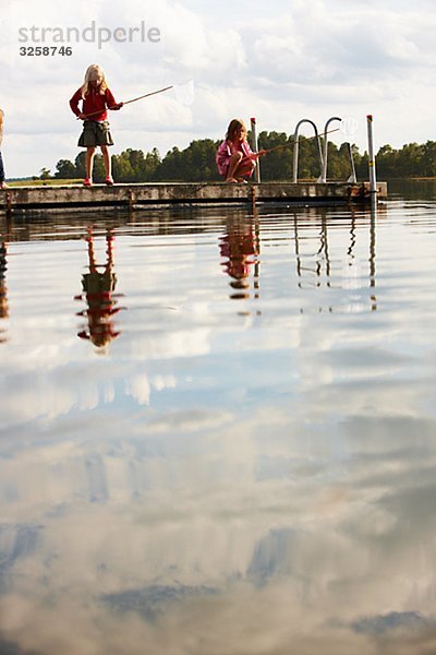 Two girls fishing  Sweden.