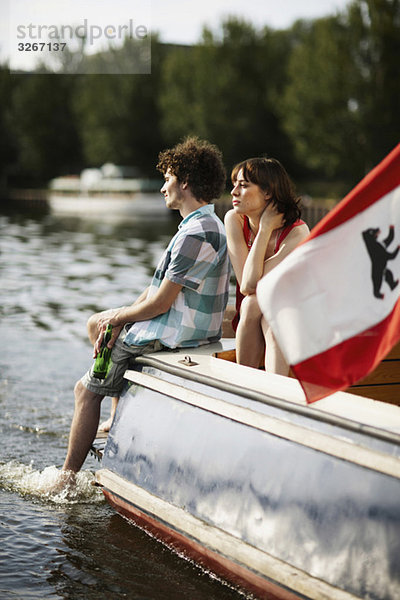 Germany  Berlin  Young couple on motor boat