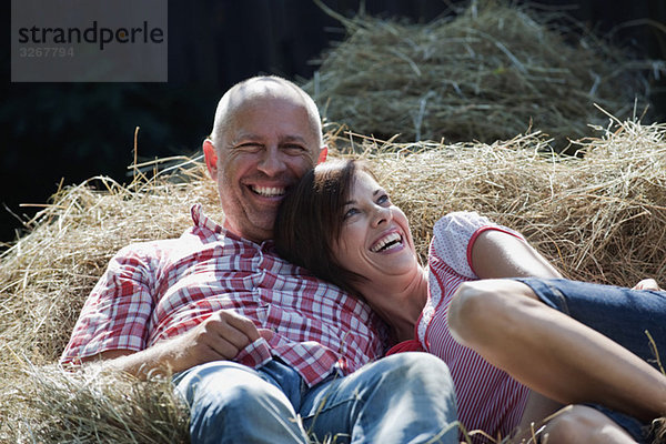 Germany  Bavaria  Couple lying on haystack