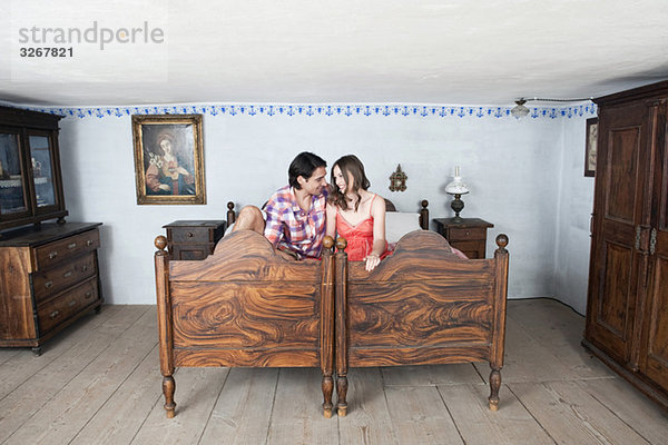 Germany  Bavaria  Young couple in rural bedroom