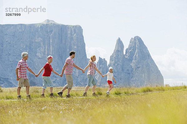 Italy  Seiseralm  Family walking in field