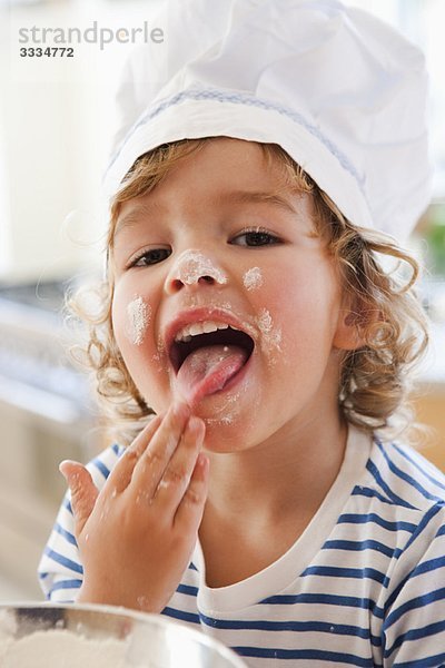 Kleiner Junge schmeckt Teig