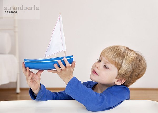 Junge mit Spielzeugboot