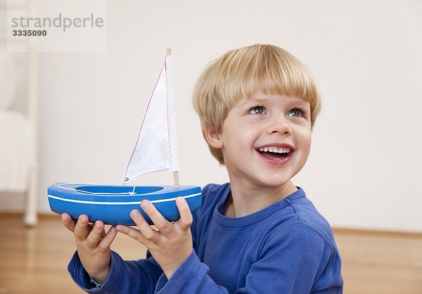 Junge mit Spielzeugboot