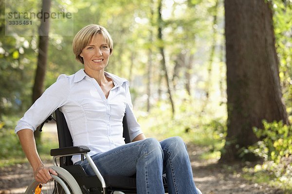 Frau mittleren Alters im Rollstuhl