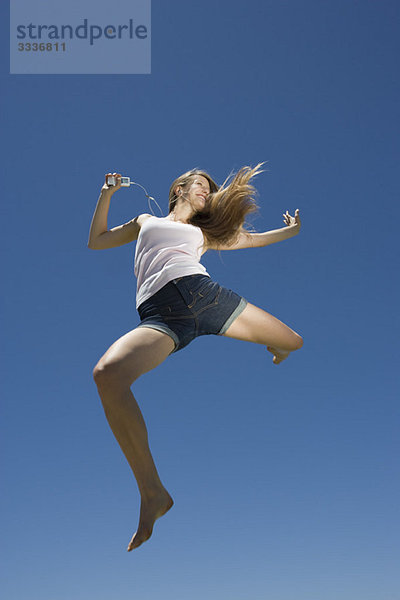 Junge Frau beim Tanzen  Springen im Freien
