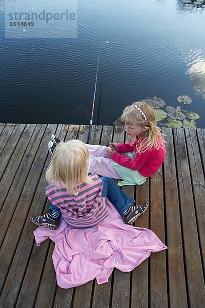 Girls angling for fish  Sweden.