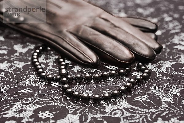 Lederhandschuh und Perlenkette  Close-up