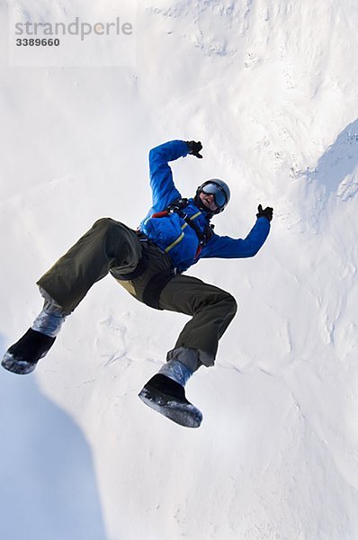 Mann gegen eine Verhüllung von Schnee  Schweden nach hinten fallen.