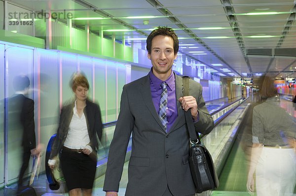 Geschäftsmann am Flughafen  zu Fuß  glücklich
