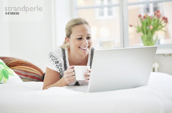 Frau mit Computer und Kaffee