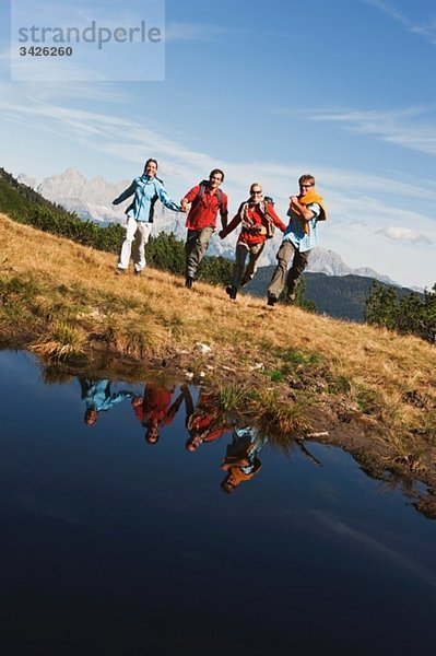 Österreich  Salzburger Land  Vier Wanderer auf dem Feld