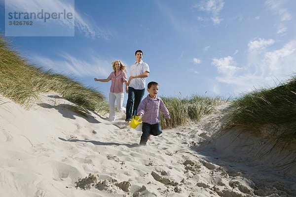 Deutschland  Schleswig Holstein  Amrum  Familie läuft die Stranddüne hinunter
