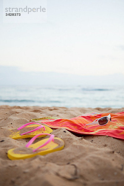 Flips Flops und Handtuch am Strand