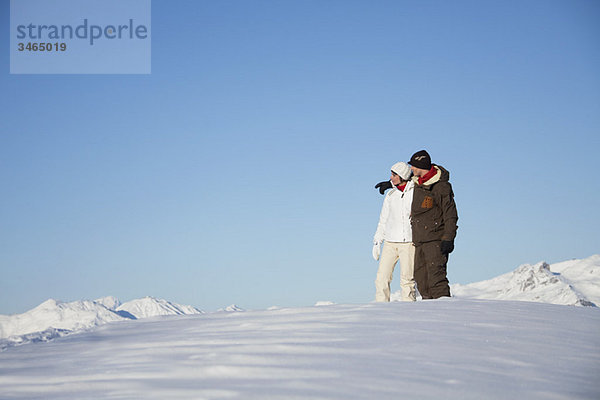 Junges Paar umarmt sich im Schnee