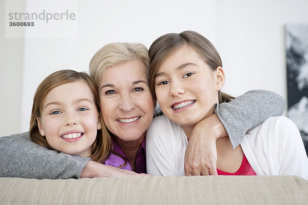 Porträt einer Frau  die mit ihren Enkelinnen lächelt