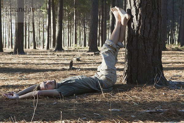 Mann im Wald auf dem Boden liegend
