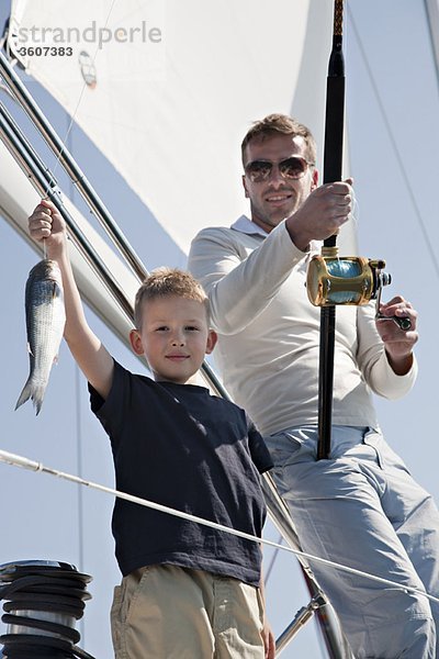 Vater und Sohn fischen auf der Yacht