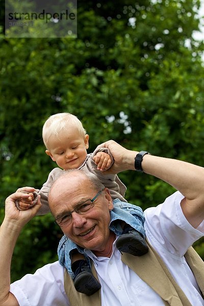 Großvater trägt Kleinkind auf den Schultern  Portrait